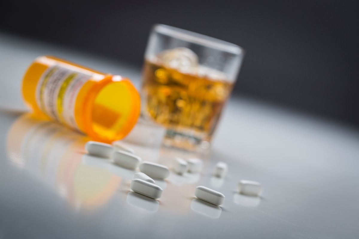Medicine pills and alcoholic drink