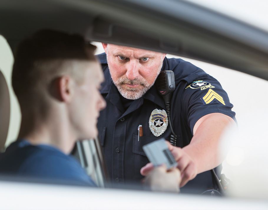 Man giving his license to a police officer