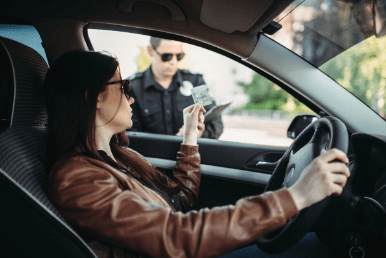 Woman giving her license to a police officer